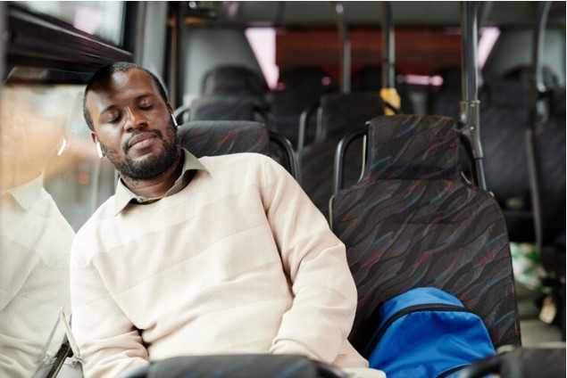 A man sleeping in a bus