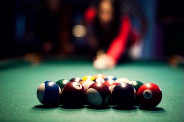 A client playing a billiard game