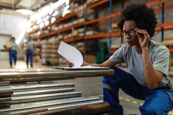 Hardware employee inspecting paperwork